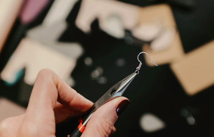 a close up of a person holding a pair of scissors
